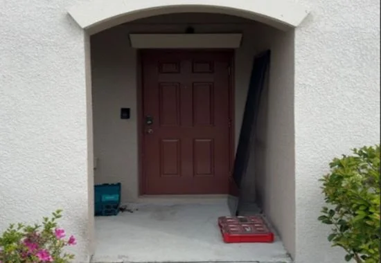 Front entryway before cleaning with dust and debris on the floor.